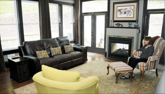  ??  ?? The family room of Michael and Helen Trask's house in Crafton. The see-through fireplace also serves the outdoor patio.