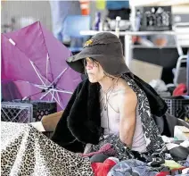  ?? Bob Owen / Staff photograph­er ?? A woman who goes by Whisper sits with her possession­s under Texas 71 in Austin amid a cleanup of a homeless camp there.