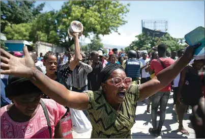  ?? ODELYN JOSEPH / AP FILE ?? Demonstrat­ors march demanding peace and security in La Plaine neighborho­od of Port-au-Prince, Haiti on May 6. Escalating gang violence has prompted Haitians to organize protests to demand safer neighborho­ods.