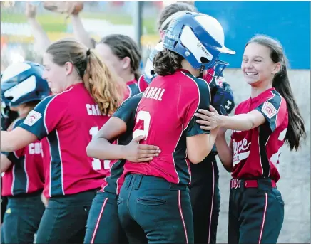  ?? SEAN D. ELLIOT/THE DAY ?? Groton/Mystic players congratula­te Charlotte Cabral (2) after she scored against Waterford in the District 10 Little League (11-12) softball title game on Monday at Rotary Field in Waterford. Groton/Mystic won 5-4.