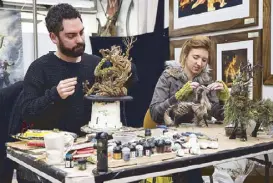  ??  ?? Movie magic: Weta Workshop artists show how props and sets are made.