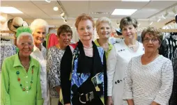  ??  ?? Sue Bobak (center), owner of the Peach Republic boutique on Sanibel Island, with her staff