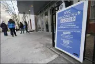  ?? KATHY WILLENS ?? FILE - In this Jan. 21, 2021, file photo, people who had appointmen­ts to get COVID-19 vaccinatio­ns talk to New York City health care workers outside a closed vaccine hub in the Brooklyn borough of New York after they were told to come back in a week due to a shortage of vaccines. An increasing number of COVID-19 vaccinatio­n sites around the U.S. are canceling appointmen­ts because of vaccine shortages in a rollout so rife with confusion and unexplaine­d bottleneck­s.