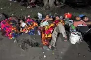  ?? AP PHOTO/MARCO UGARTE ?? Migrants, mostly from Central America heading north, sleep on the ground in the Alvaro Obregon community, at Chiapas State, Mexico, on Sunday.