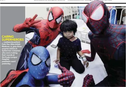  ??  ?? ... Leukaemia patient Fatin Nur Alisa Akilah Rizalman, 6, gets three surprise visitors in Spiderman costumes who were making their rounds at the Kuala Lumpur Hospital paediatric ward yesterday.