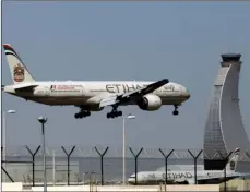  ??  ?? In this May 4, 2014, file photo, an Etihad Airways plane prepares to land at the Abu Dhabi airport in the United Arab Emirates. AP PHOTO/KAMRAN JEBREILI