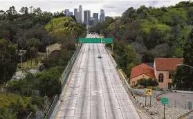  ?? Associated Press file photo ?? Light traffic moves along a freeway near Los Angeles right before rush hour, when traffic would be bumper-to-bumper if not for the pandemic.