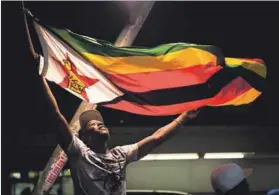  ??  ?? Joy: Zimbabwean­s celebrate a new era for their country in Joburg’s streets. South Africans may feel ‘coup’ envy. Photo: Delwyn Verasamy