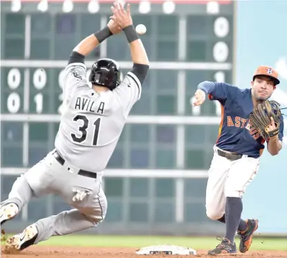  ?? | AP ?? The Astros’ Jose Altuve tries to complete a double play after forcing the Sox’ Alex Avila in the sixth inning. Brett Lawrie beat the relay.