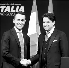  ?? — Reuters photo ?? File photo of Di Maio (left) shaking hands with Conte in Rome.