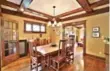  ??  ?? Features of the dining room include wood beams on the ceiling.