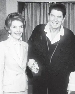  ?? MIKE EVENS/GETTY-AFP 1981 ?? President Ronald Reagan, seen with first lady Nancy Reagan, was shot and nearly killed by an assassin’s bullet less than three months into his first term. He would serve two terms.