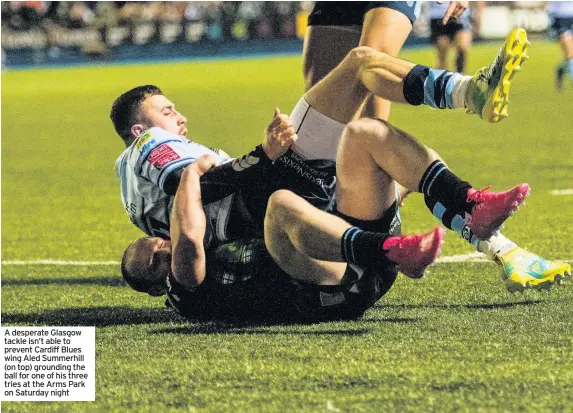  ??  ?? A desperate Glasgow tackle isn’t able to prevent Cardiff Blues wing Aled Summerhill (on top) grounding the ball for one of his three tries at the Arms Park on Saturday night