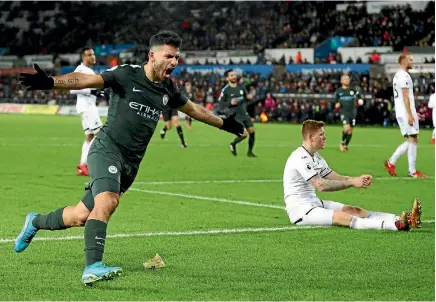  ??  ?? Sergio Aguero celebrates scoring for Manchester City in their 4-0 rout of Swansea City in the Premier League.