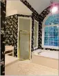  ?? JOHNSON BETH ?? Magnolia wallpaper dated and darkened the bathroom of a Milton home before a renovation.