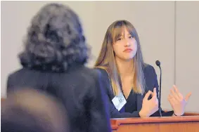  ??  ?? Pojoaque’s Samantha Baca appears as a witness under cross-examinatio­n by Albuquerqu­e Academy’s Raajvi Patel during the state mock trial competitio­n on March 17.