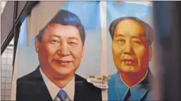  ?? AFP FILE ?? ▪ Painted portraits of Xi Jinping (left) and Mao Zedong at a Beijing market.