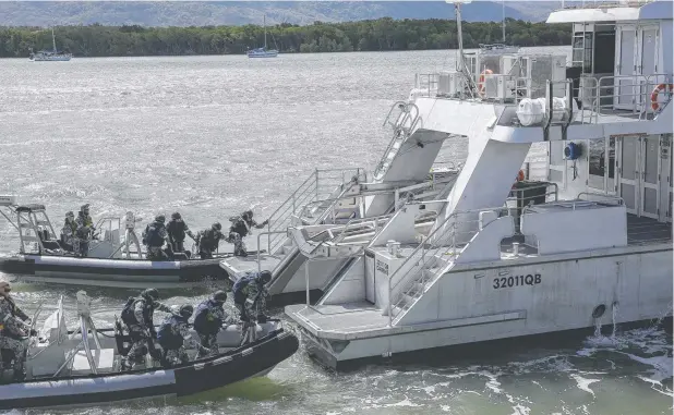  ??  ?? ACTION: Royal Australian Navy, boarding party personnel demonstrat­e a search of a simulated suspect vessel during the live exercise demonstrat­ion on Saturday at the Proliferat­ion Security Initiative, Exercise Pacific Protector.