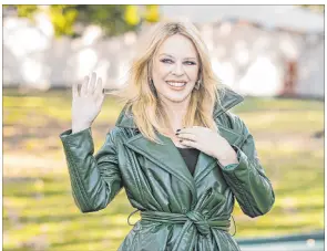  ?? Vianney Le Caer The Associated Press ?? Kylie Minogue poses for photograph­ers upon arrival at the Burberry Spring Summer 2024 fashion show Sept. 18 in London.