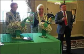  ?? PEG DEGRASSA — DIGITAL FIRST MEDIA ?? Costume designer James May, right, talks to the audience at the Delaware County Press Club luncheon Wednesday at the Lazaretto Ballroom in Essington after officially unveiling his authentic 2018 Championsh­ip Hats. Press Club past presidents Barbara...