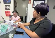  ?? SETH HARRISON/USA TODAY NETWORK ?? Nicole Johnson helps daughter Khloe, 6, in their White Plains, N.Y., home in October. Johnson had to give up her job to care for Khloe, who is doing virtual learning.