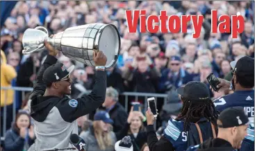  ?? CP PHOTO / CHRIS YOUNG ?? Toronto Argonauts James Wilder Jr. holds the Grey Cup as he shows it to fans gathered in Toronto's Nathan Phillips Square as the team hold a Cup winning rally on Tuesday. Toronto celebrated their 27-24 win over Calgary Stampeders to win the 2017 Grey...