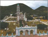  ??  ?? Graves surround the church of San Jeronimo Xayacatlan, Mexico. Most residents departed in the 1990s or the first decade of the 21st century, leaving behind farm work to cross illegally into the United States.