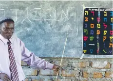  ?? (Patrick Olum/Reuters) ?? UGANDAN RABBI Harun Kintu Moses conducts a Hebrew lesson at a Jewish community institute in Mbale, Uganda.