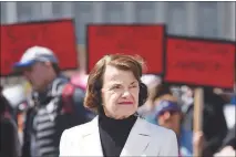  ?? JOSH EDELSON / AP ?? U.S. Sen. Dianne Feinstein, D-calif., speaks to members of the media March 24 in San Francisco as crowds of people participat­e in the March for Our Lives rally in support of gun control. Feinstein is perhaps best known for her quest over 25 years in Congress to enact stricter national gun control, including authoring the now-expired original assault weapons ban.