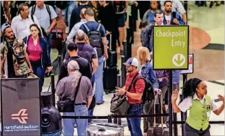  ?? JOHN SPINK/JSPINK@AJC.COM ?? You’re more likely to pick up a virus while waiting in line at the airport than on the airplane itself, according to aerospace medicine specialist Quay Snyder, because the air is exchanged more frequently on a plane.