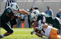  ?? AP/AL GOLDIS ?? Central Michigan quarterbac­k Tommy Lazzaro (bottom) is tackled by Michigan State’s Justin Layne (2) and Mike Panasiuk (72) during the fourth quarter Saturday in East Lansing, Mich. Michigan State is allowing 40.3 yards per game and 1.49 yards per carry, the lowest numbers in the nation by a wide margin.