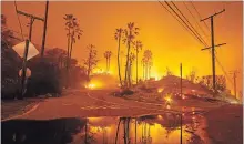  ?? KYLE GRILLOT THE WASHINGTON POST ?? The Woolsey Fire burns above Malibu, forcing thousands to evacuate.