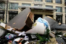 ?? AFP via Getty Images ?? Debris lies in front of the Radisson Blu hotel, where a huge aquarium located in the hotel’s lobby burst on Friday in Berlin.