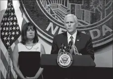  ?? ISAAC BREKKEN/AP PHOTO ?? Vice President Mike Pence, accompanie­d by his wife, Karen, speaks in Las Vegas on Saturday, following a unity prayer walk honoring the victims of last weekend’s massacre.