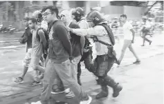  ??  ?? Police detain protesters during a rally against Maduro’s government in Caracas,Venezuela. — Reuters photo