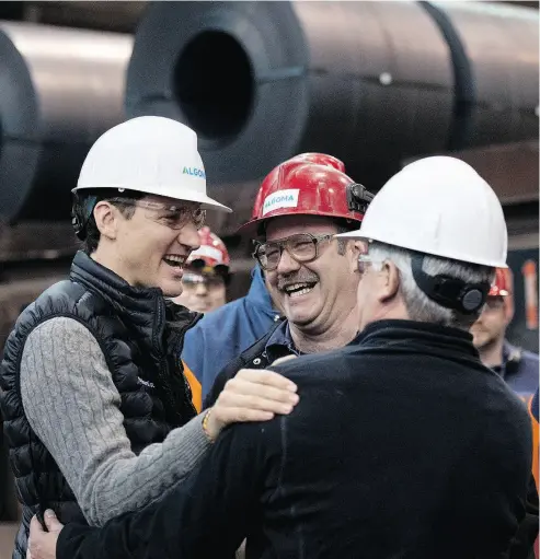  ?? JUSTIN TANG / THE CANADIAN PRESS FILES ?? He’s “got their backs”: Prime Minister Justin Trudeau meets with workers during a tour at Essar Steel Algoma in Sault Ste. Marie, Ont., on Wednesday.