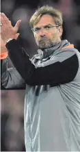  ??  ?? Fan-tastic: Jurgen Klopp salutes Reds fans last night