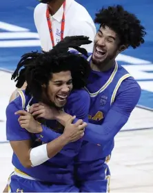  ?? Getty images file ?? ALL SMILES: UCLA’s Johnny Juzang, right, and Tyger Campbell celebrate after beating Michigan in the Elite Eight at Lucas Oil Stadium on Tuesday in Indianapol­is.
