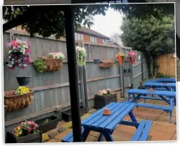  ?? ?? There was no shortage of blue picnic tables in the outside area at the back of the pub, likewise selections of colourful plastic flowers