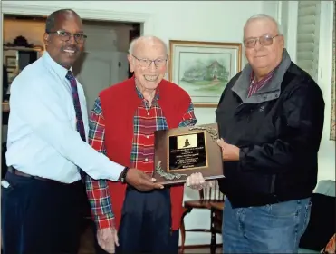  ?? Doug Walker ?? Flanked by the Rev. Carey Ingram (left) and Jerry Rucker, Mike Mcdougald is presented with a plaque honoring him as the grand marshal of the Rome Christmas Parade at his home Tuesday. The Dec. 1 event will be a drive-through display in the State Mutual Stadium west parking lot from 6 to 8 p.m.