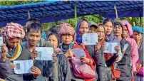  ?? PTI ?? voters show their identity card as they stand at a polling station during the assembly polls at Kanhmun in Mizoram. —