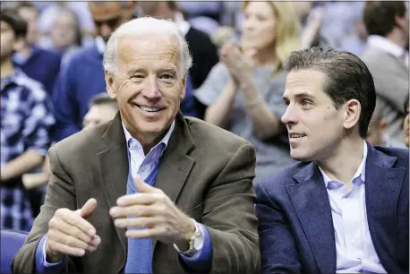  ?? NICK WASS — THE ASSOCIATED PRESS FILE ?? In this file photo, Vice President Joe Biden, left, with his son Hunter, right, at the Duke Georgetown NCAA college basketball game in Washington. Since the early days of the United States, leading politician­s have had to contend with awkward problems posed by their family members. Joe Biden is the latest prominent politician to navigate this tricky terrain.