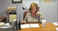  ?? Photo by Ernest A. Brown ?? Woonsocket Animal Control Officer Doris Kay handles a call at her desk on Wednesday.