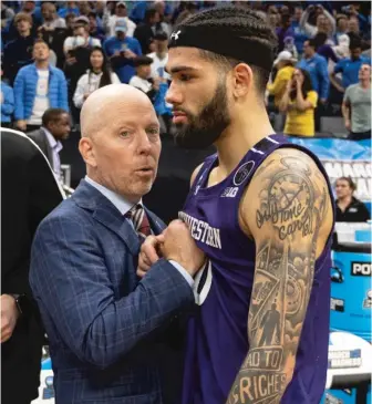  ?? JOSE LUIS VILLEGAS/AP ?? UCLA coach Mick Cronin consoles Northweste­rn guard Boo Buie after the Wildcats’ loss.