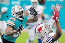  ?? JOHN MCCALL/SUN SENTINEL ?? Bills wide receiver Zay Jones can’t get his hands on the ball as Dolphins cornerback Xavien Howard closes in Sunday at Hard Rock Stadium.