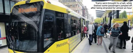  ??  ?? Trams were brought to a halt, while (below) some passengers jumped off after being stranded for almost an hour