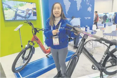  ?? Picture: AFP ?? IN WITH THE NEW. Jia Ren shows off Okai’s latest electric bicycle models at the Consumer Electronic­s Show in Las Vegas on Tuesday. Some 44 million e-bikes were sold worldwide last year and that number is expected to top 77 million by the year 2030, according to market tracker Statista.