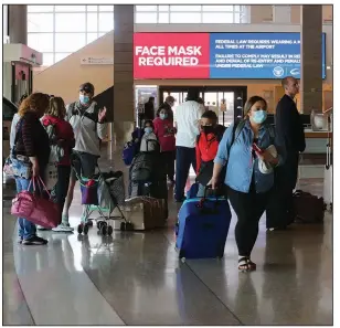  ?? (Arkansas Democrat-Gazette/Thomas Metthe) ?? Travelers wait in line to check in for flights Friday at Bill and Hillary Clinton National Airport/Adams Field in Little Rock as the holiday weekend starts.