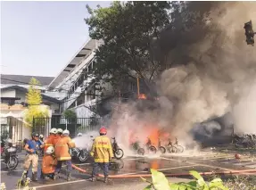  ??  ?? Firefighte­rs battle the blaze at Pentecost Church Central Surabaya yesterday.