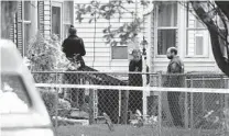  ?? TINA MACINTYRE-YEE AP ?? Rochester police look over the area of a home after a fatal shooting at a backyard house party Saturday in Rochester, N.Y.